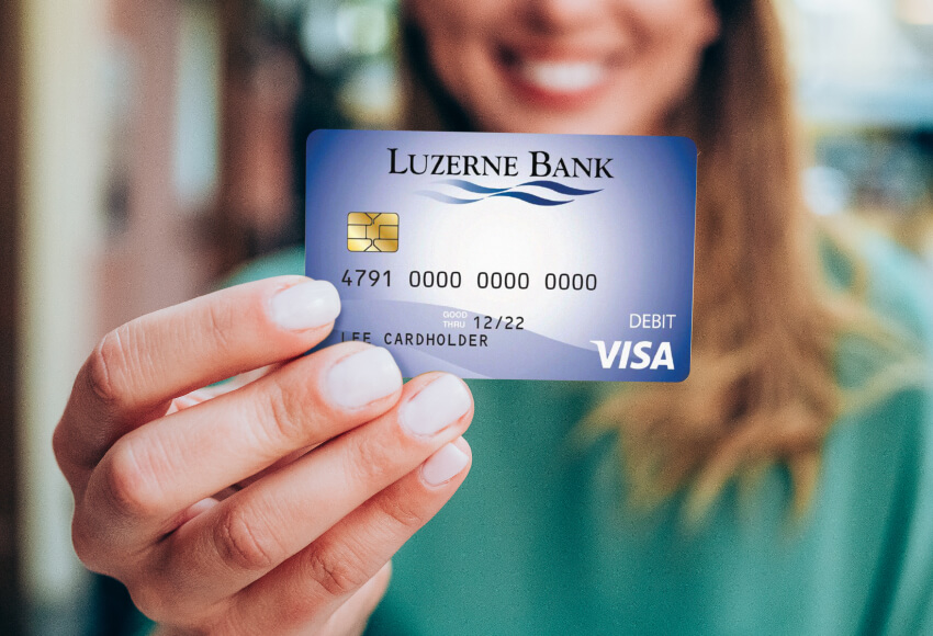 Woman holding Luzerne Bank credit card.
